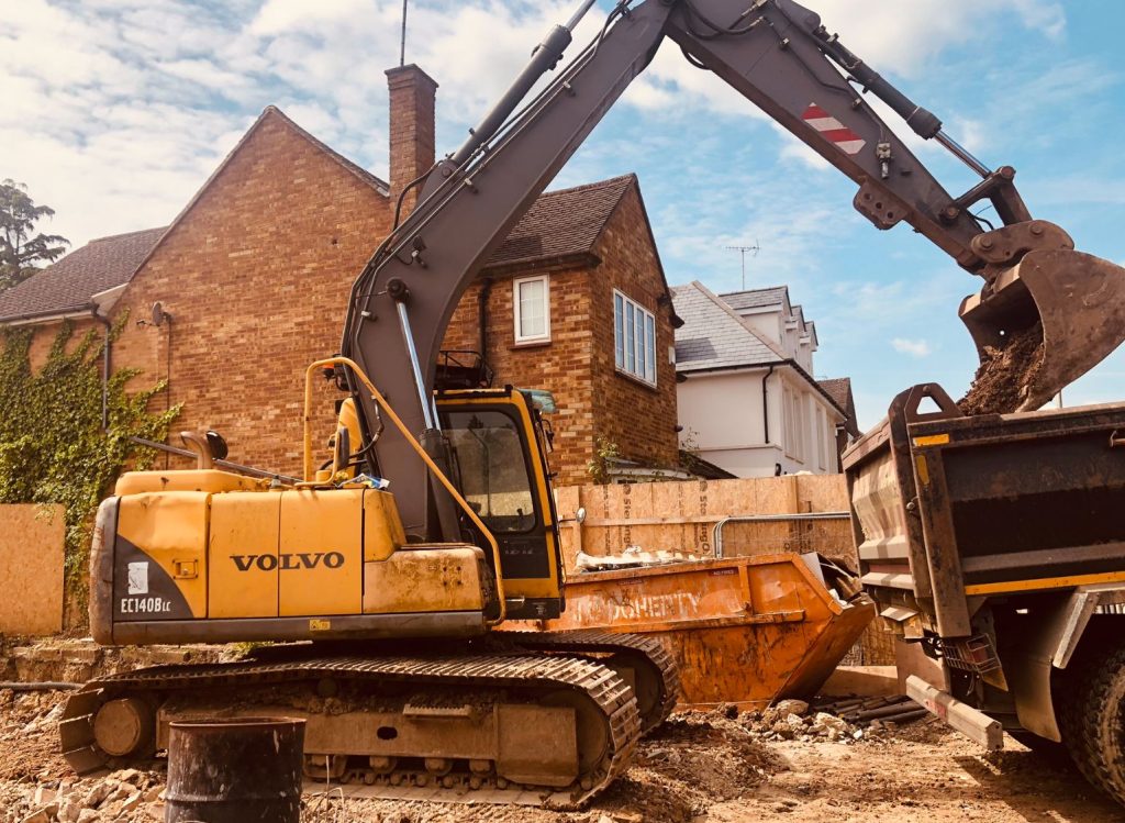 A concrete foundation being poured in a backyard.